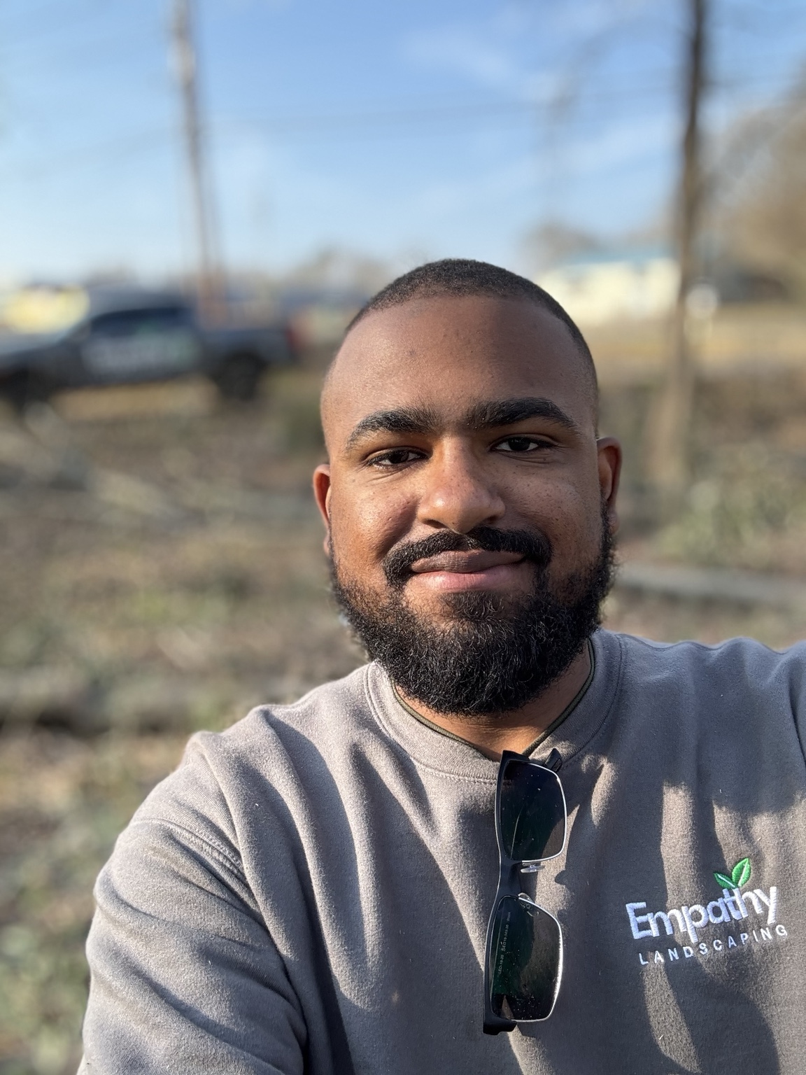 Eddison Michael wearing his Empathy Landscaping shirt outdoors